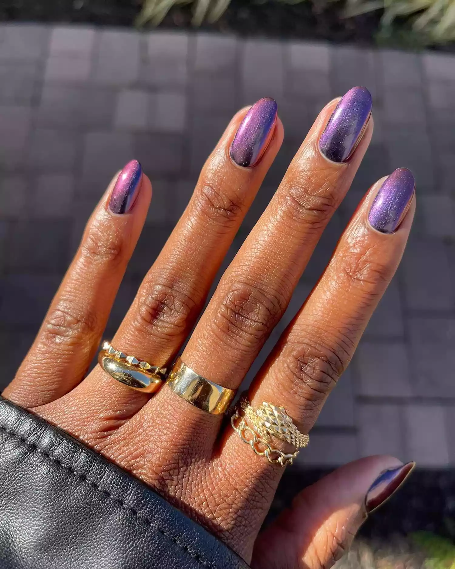 A dark purple chrome manicure