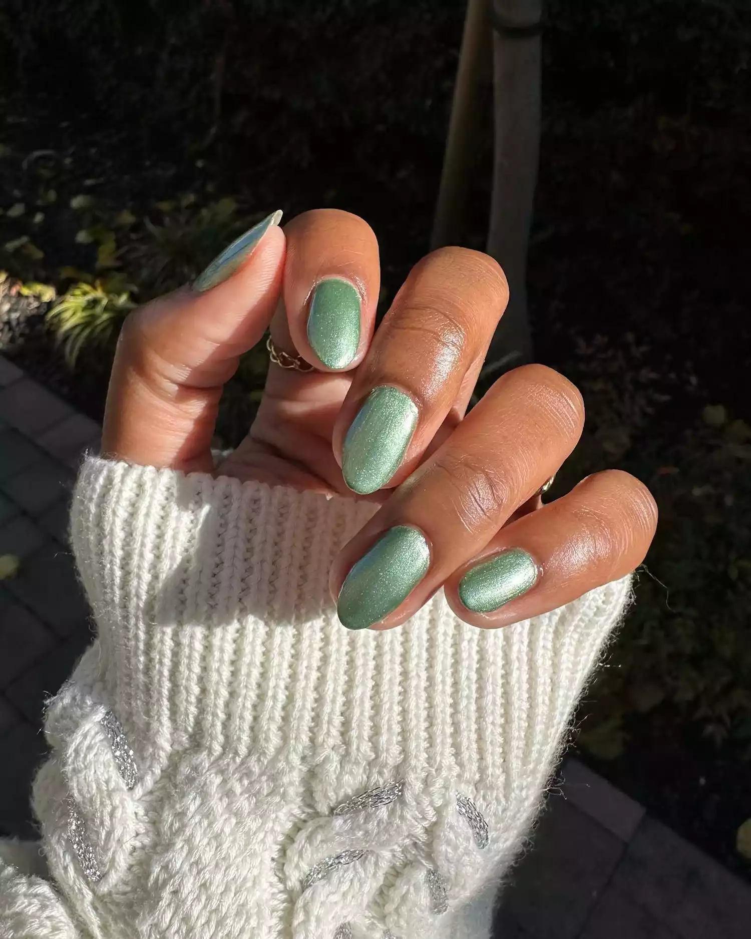 A green chrome manicure