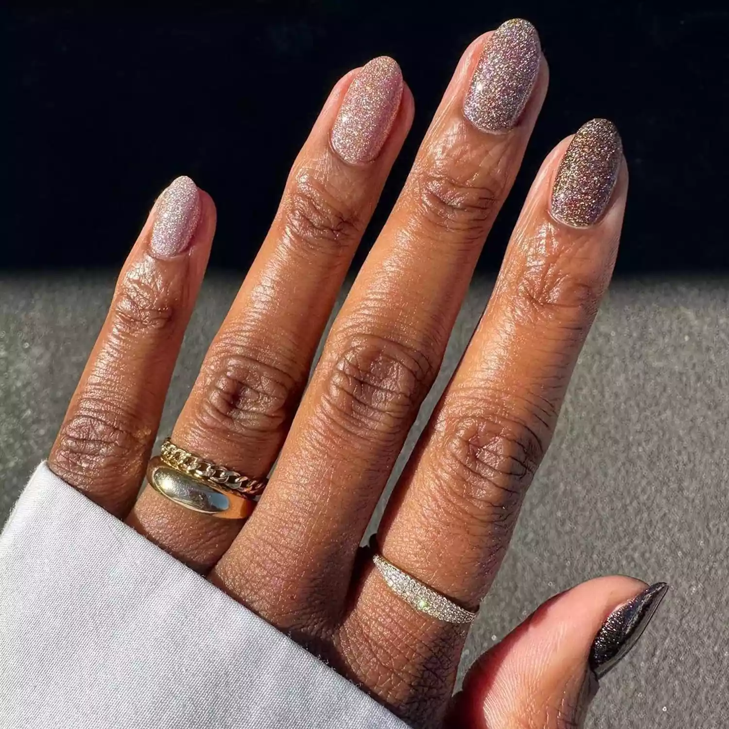 A glittery manicure in various shades of brown