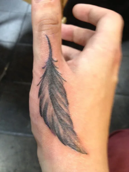 A Feather Tattoo Design On Hand