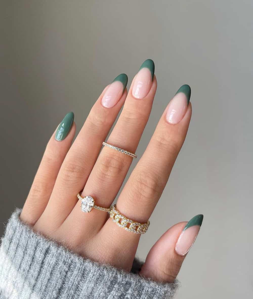 hand with sage green French tip nails