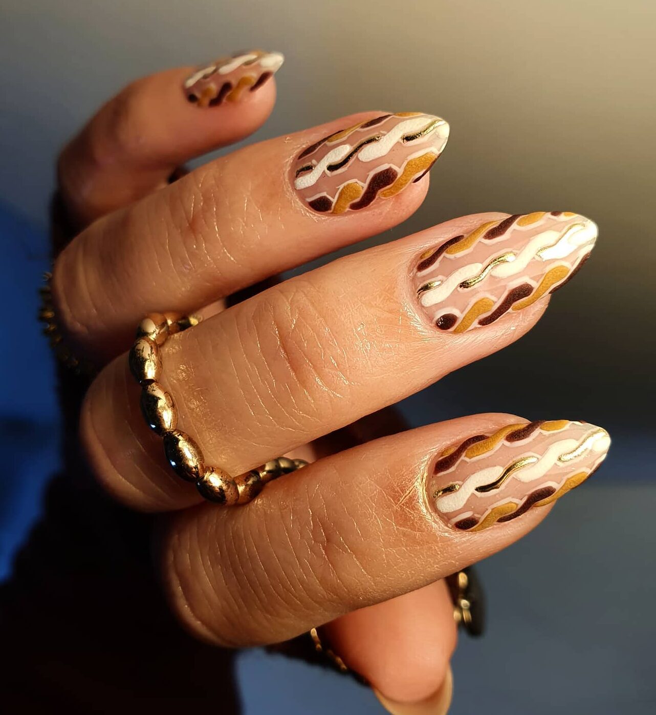 Multicolored geometric pattern on long almond nails