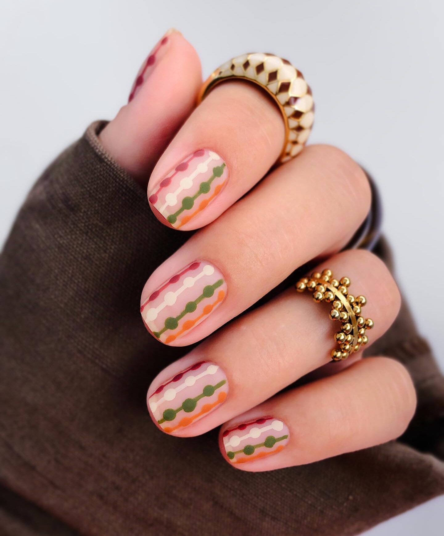 Multicolored matte geometric nail art on short square nails