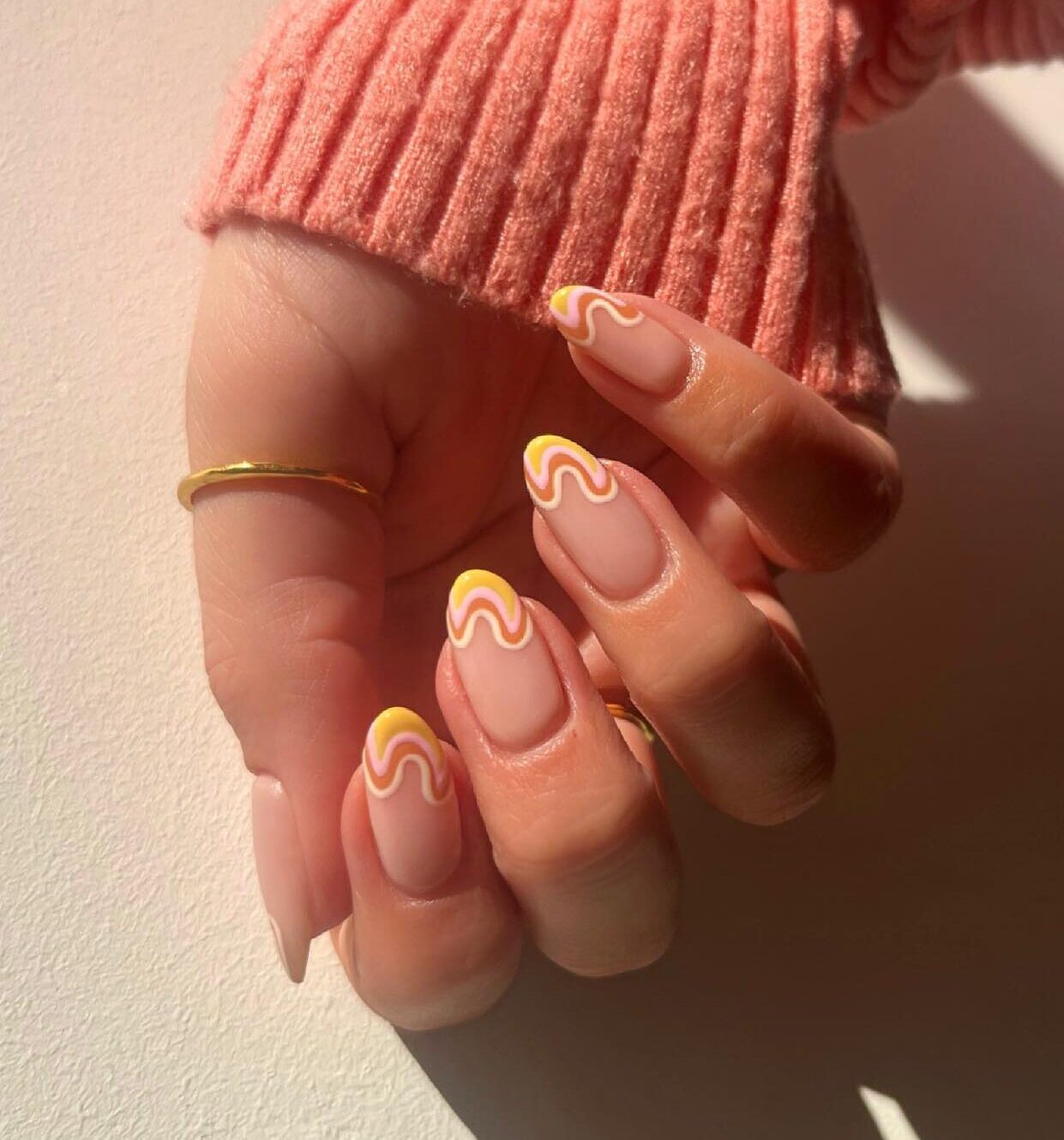 Yellow and orange swirly French tips on short round nails