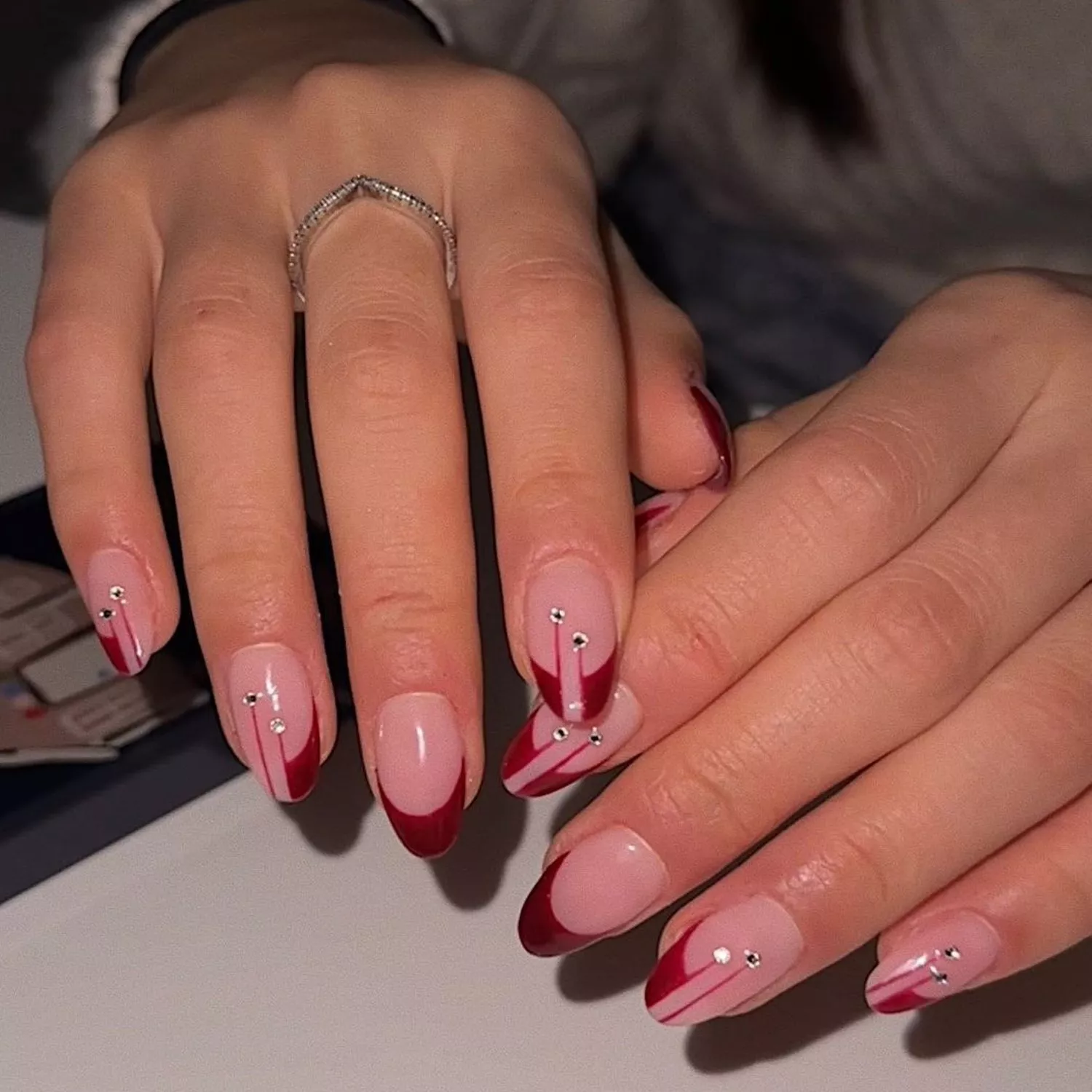 Oxblood French manicure with diamond accents