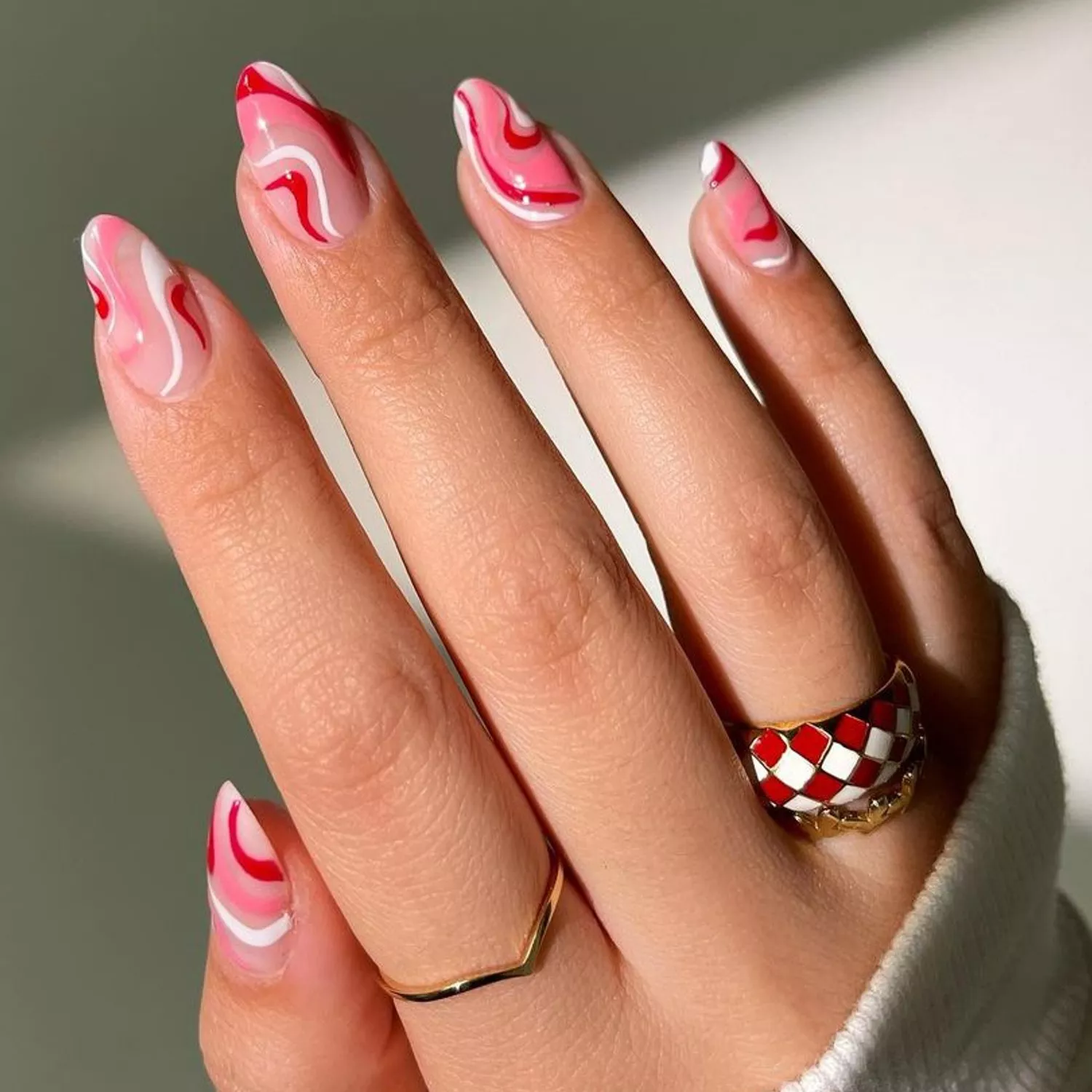 Red, pink, and white swirl manicure