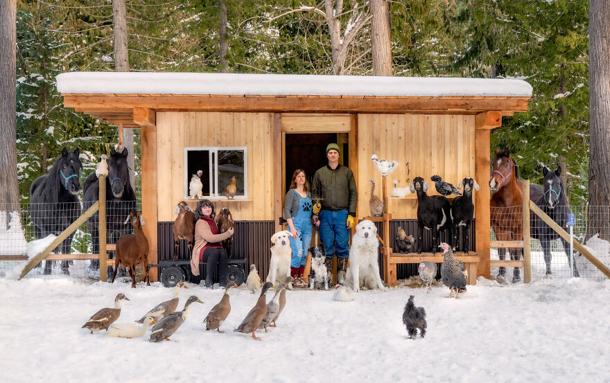 a group of people in front of a house covered in snow