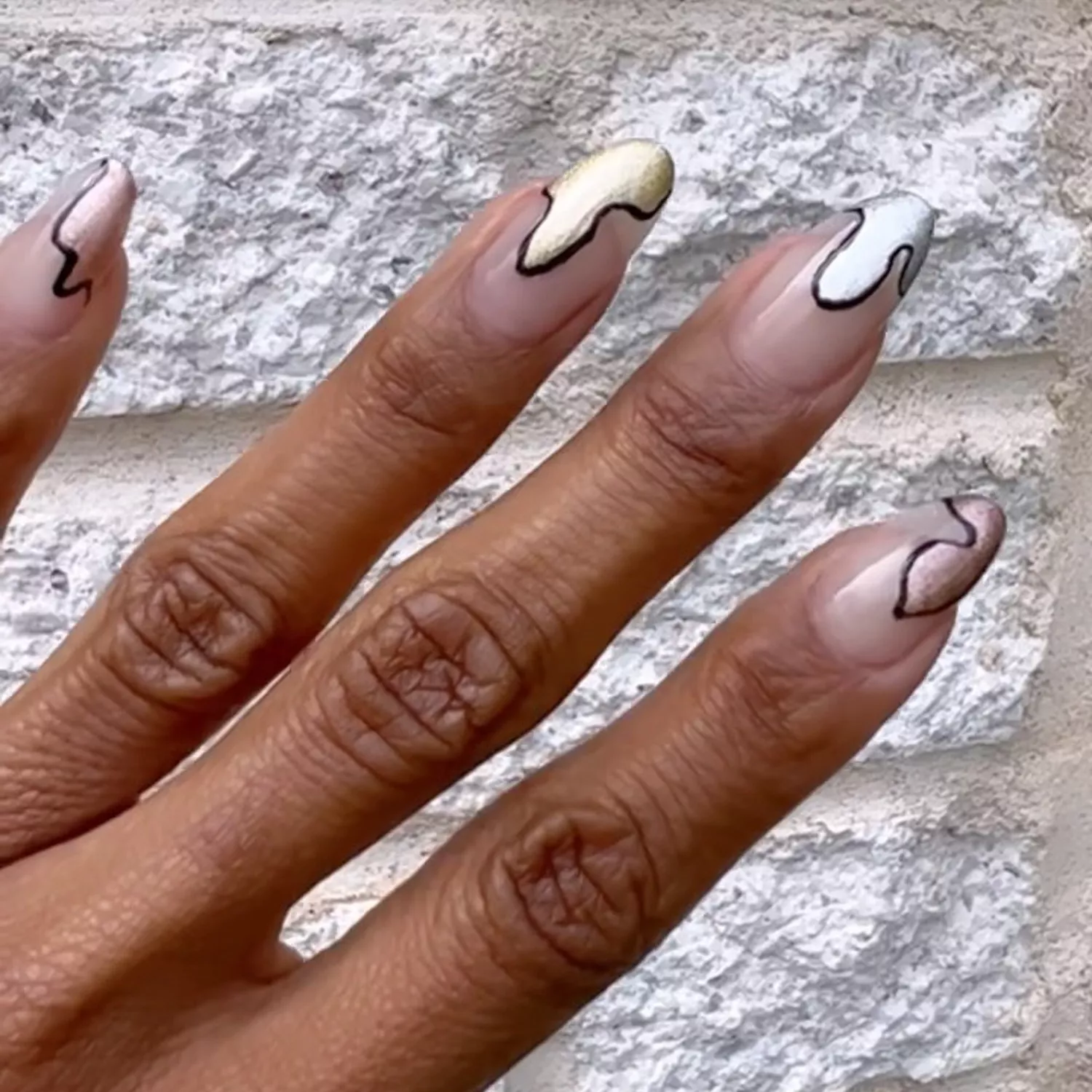 A manicure with metallic drippy tips