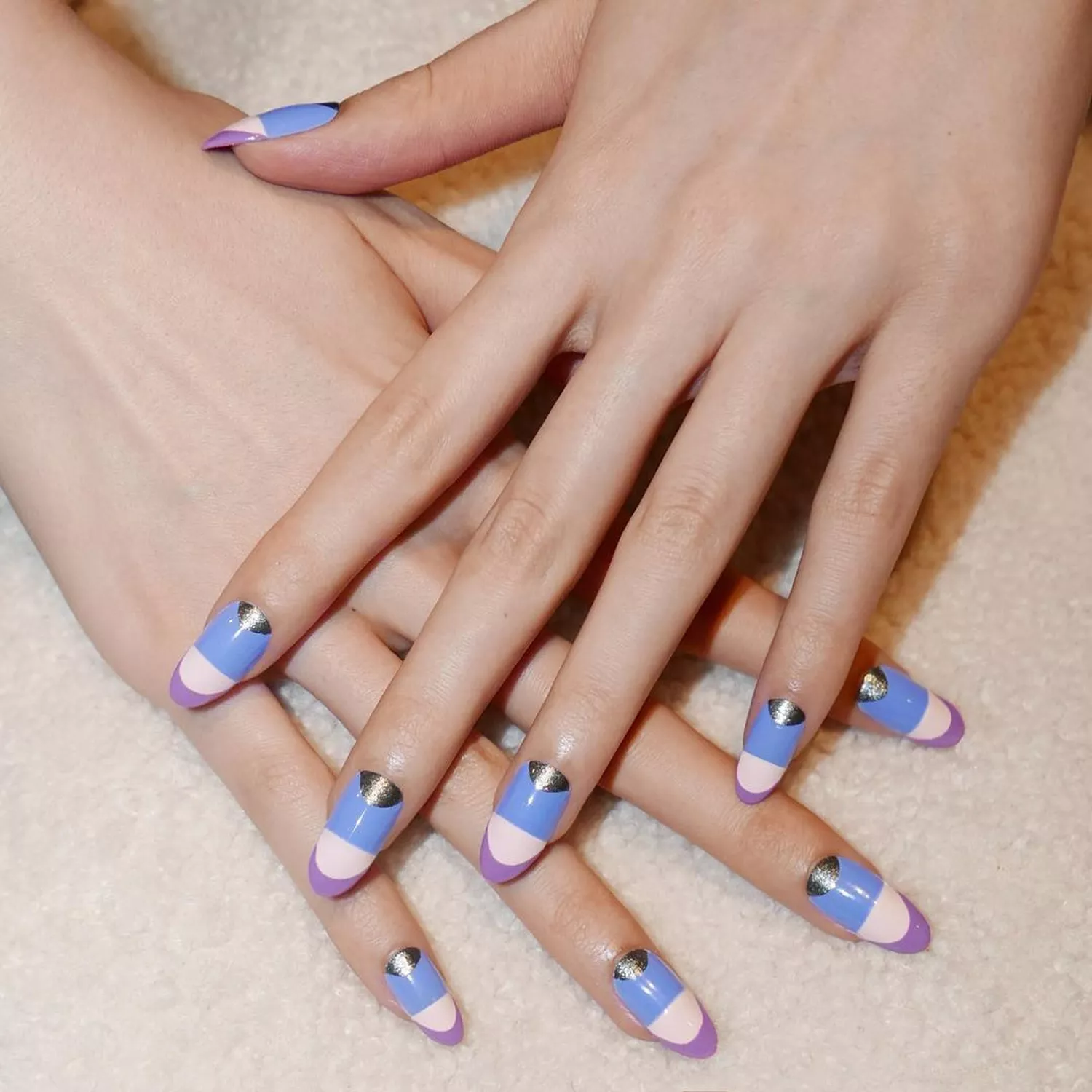 A manicure in shades of blue, purple, and silver, with purple tips