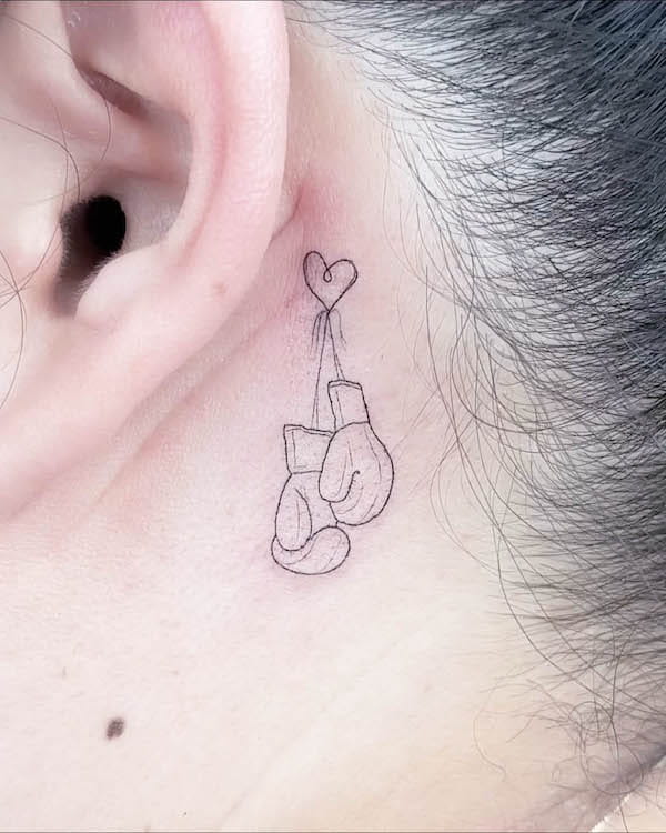 Boxing gloves behind-the-ear tattoo by @sop_tatto