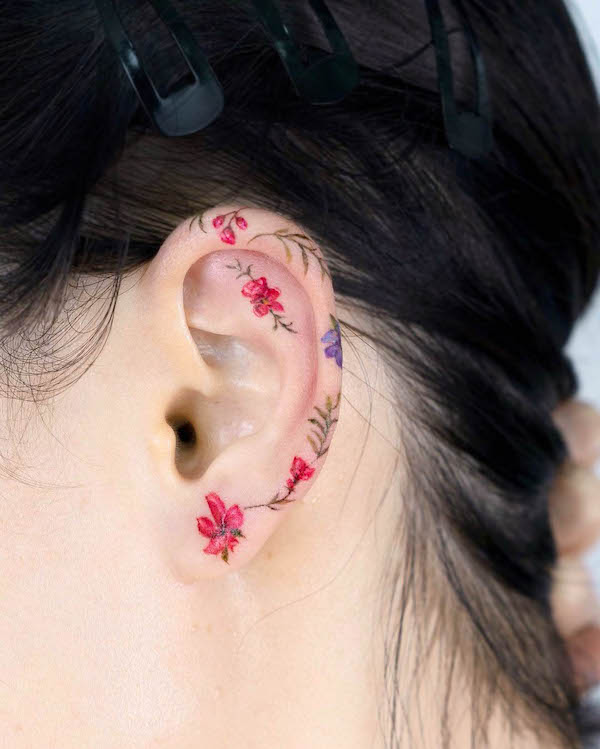 Flowers ear tattoo by @tilda_tattoo