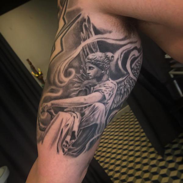 Guardian angel bicep tattoo