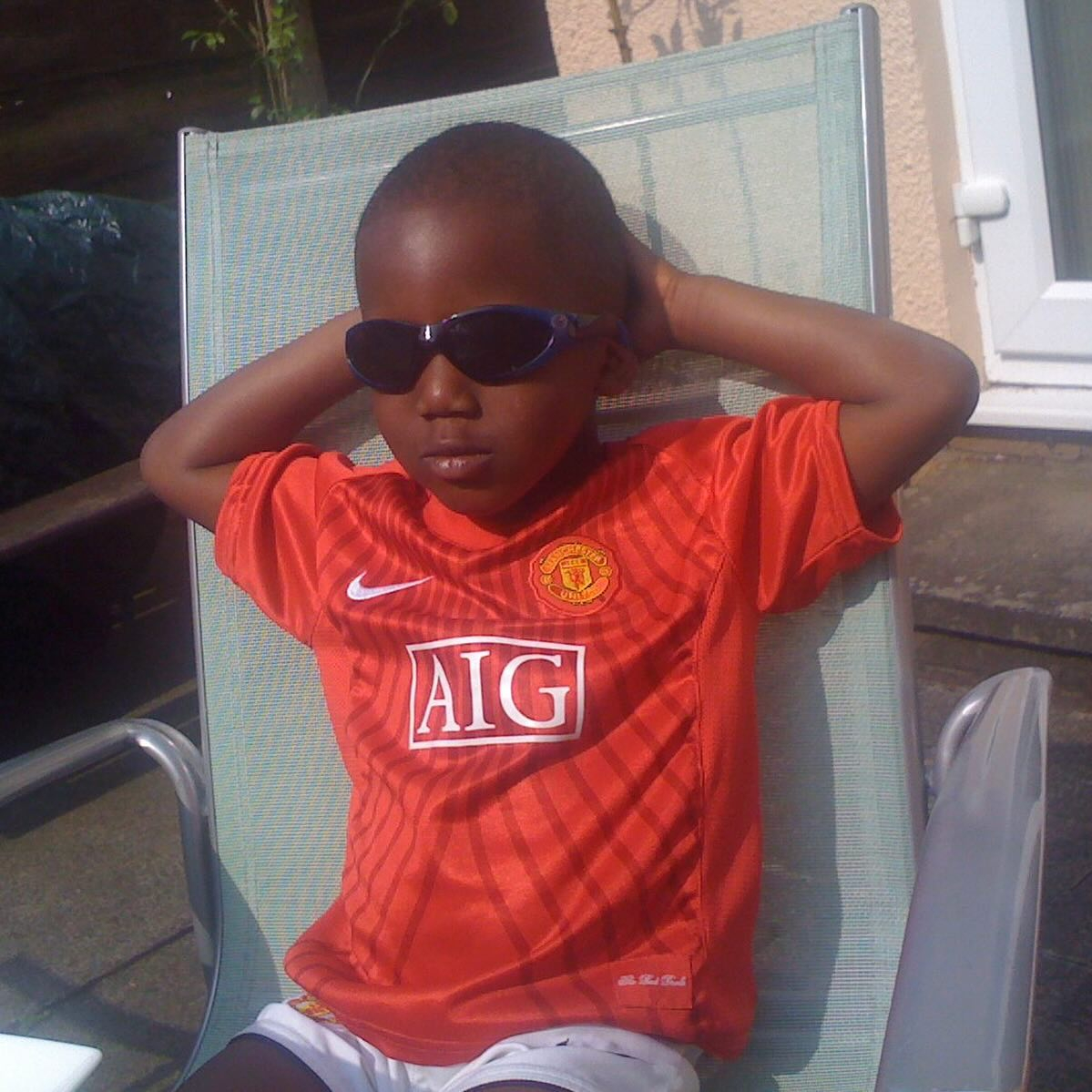 Kobbie Mainoo shared a snap of himself wearing a Man Utd AIG kit as a youngster