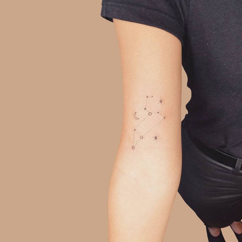 Leo constellation tattoo located on the bicep