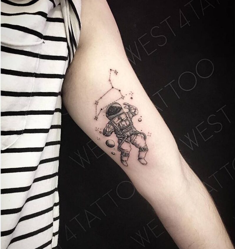 Leo constellation and astronaut tattoo on the left inner arm