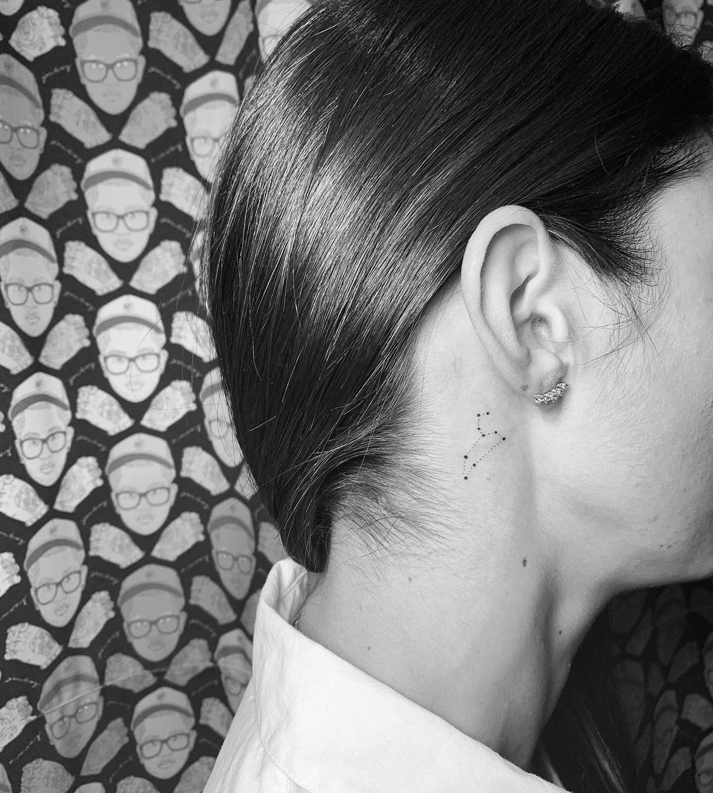 Tiny and minimalistic Leo constellation tattoo behind the ear