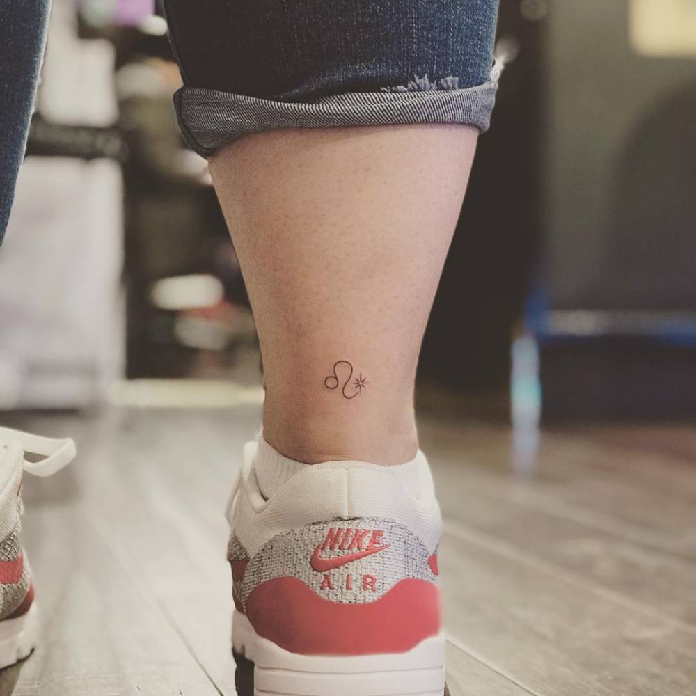 Leo zodiac symbol tattoo located on the ankle