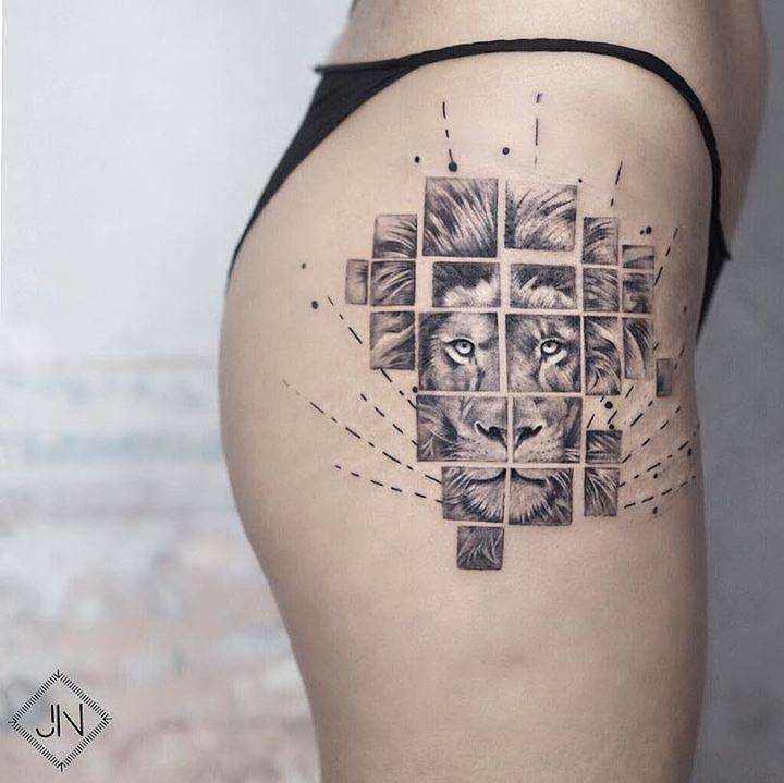 Graphic lion head tattoo on the hip