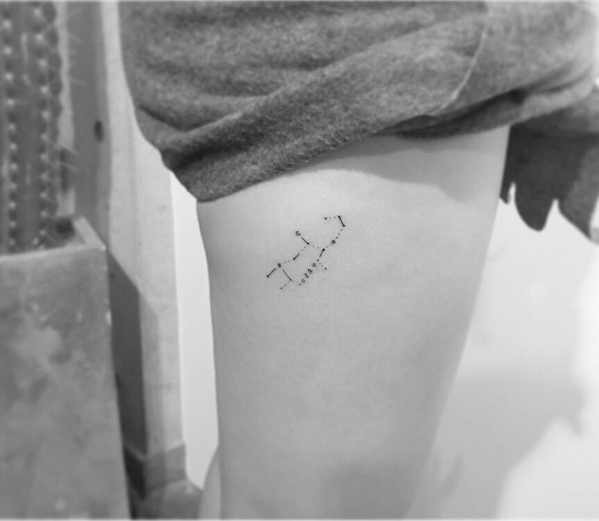 Minimalistic Virgo constellation tattoo located on the thigh