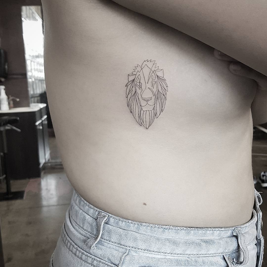 Continuous line lion portrait tattoo located on the side boob