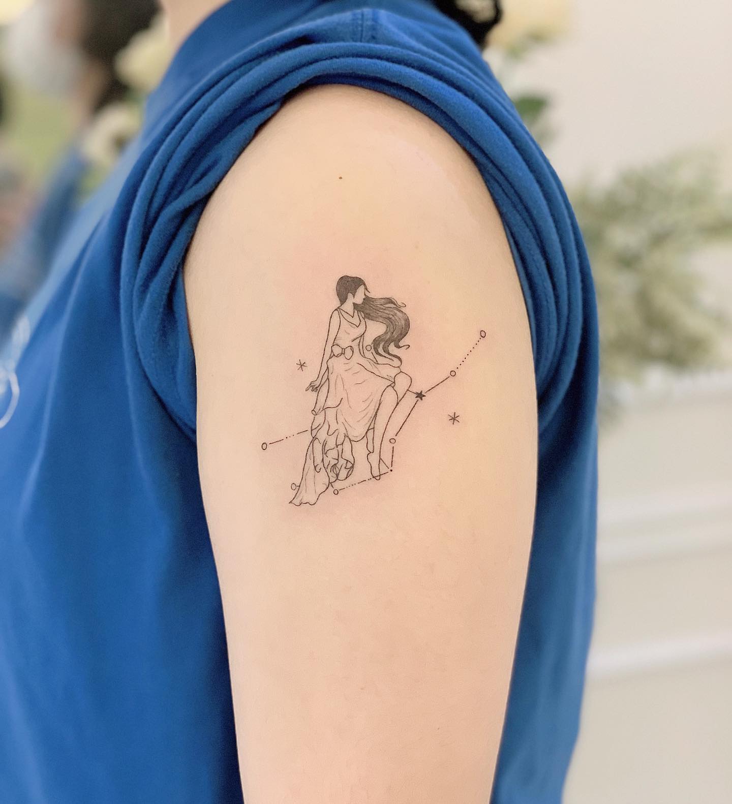 Virgo lady and Virgo constellation tattoo on the upper arm