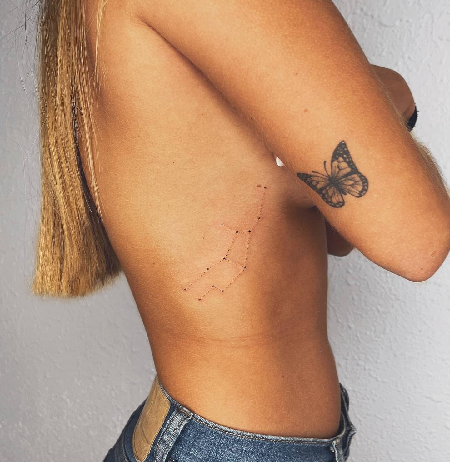 Minimalist Virgo constellation tattoo on the rib