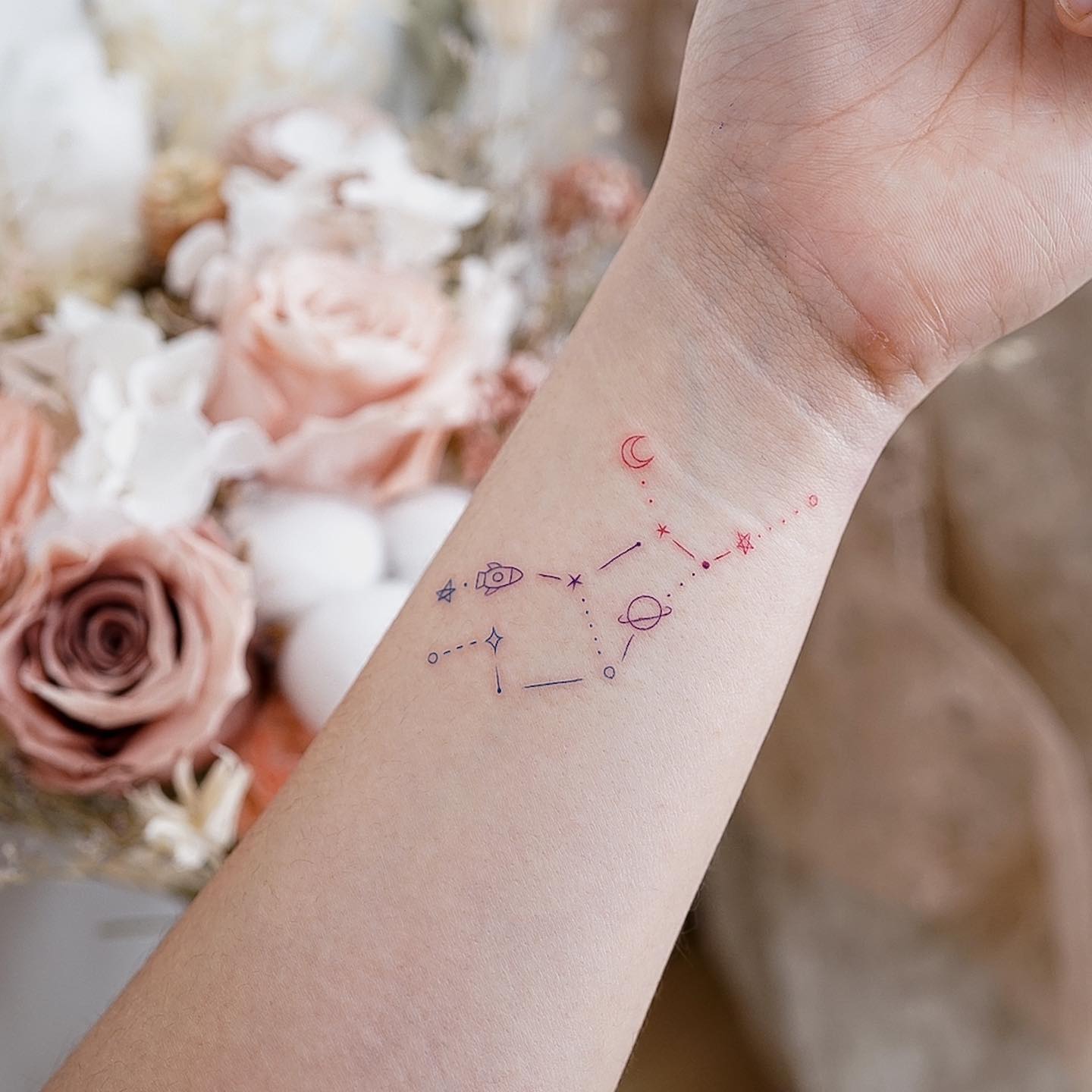 Fine line Virgo constellation tattoo on the wrist