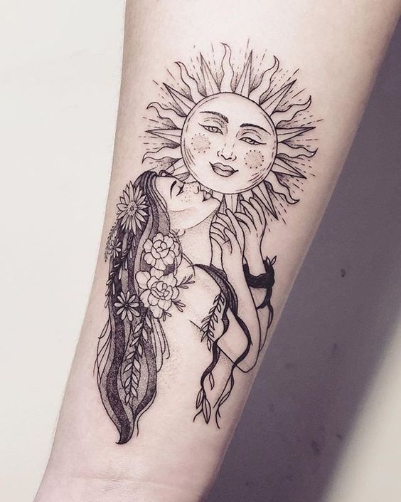 Virgo goddess and sun tattoo on the inner forearm