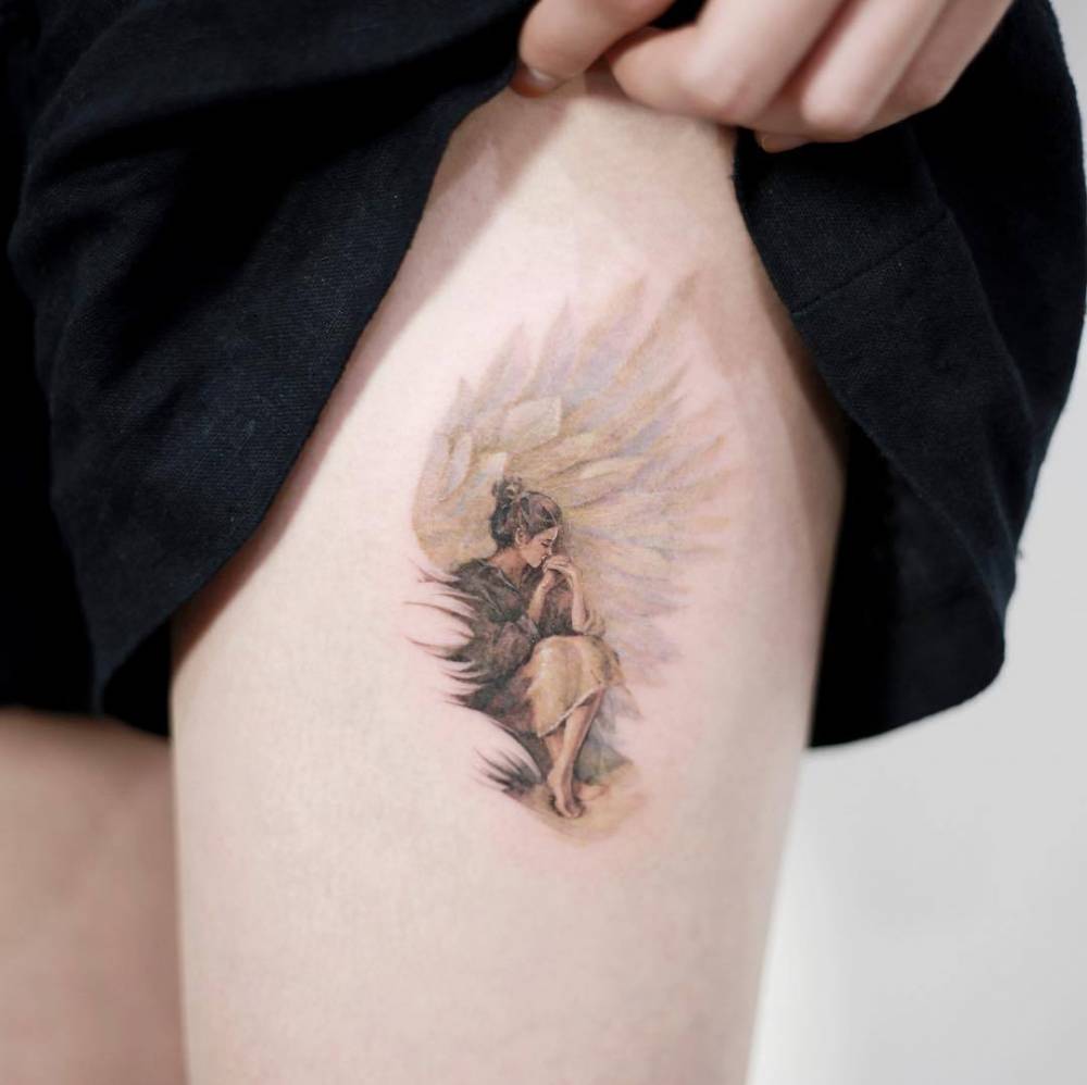 Virgo angel tattoo located on the thigh
