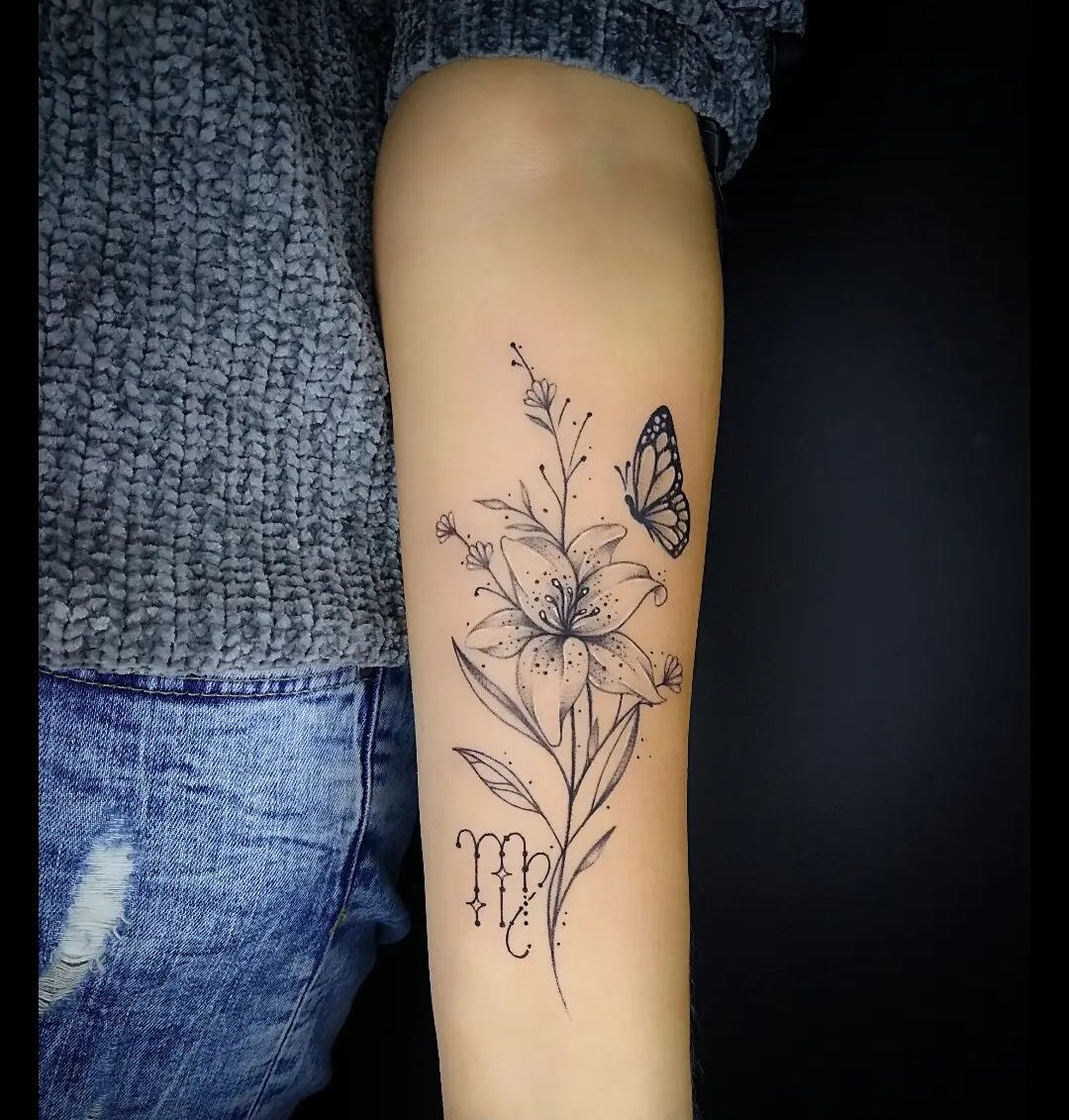 Virgo zodiac symbol and flower tattoo on the inner forearm