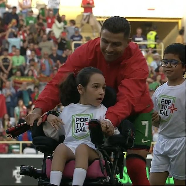 Cristiano Ronaldo helped a disabled mascot onto the pitch before his side's clash with Ireland