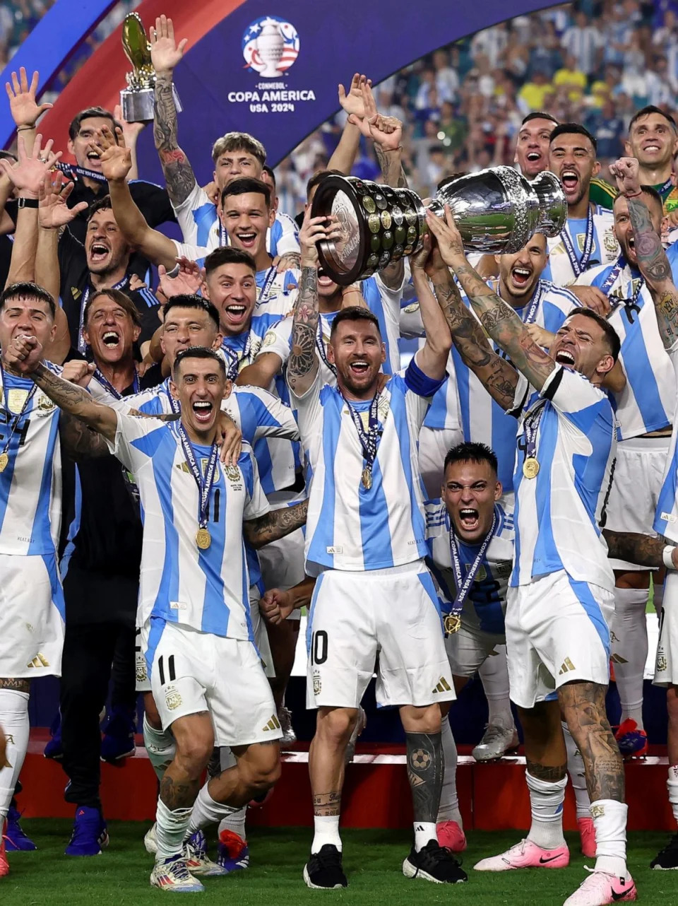 PHOTO: Argentina's Lionel Messi lifts the trophy as he celebrates with teammates after winning Copa America 2024 in Miami, FL, July 14, 2024. (Agustin Marcarian/Reuters)