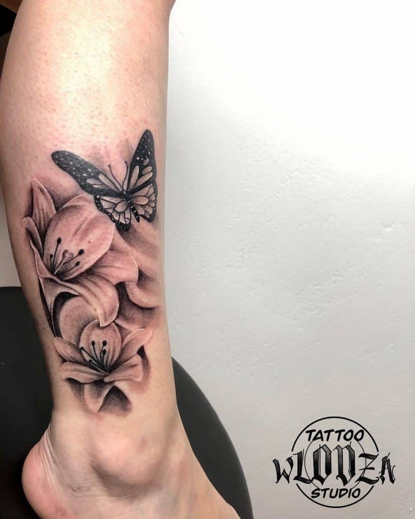 Lily Tattoo With A Butterfly Over Leg